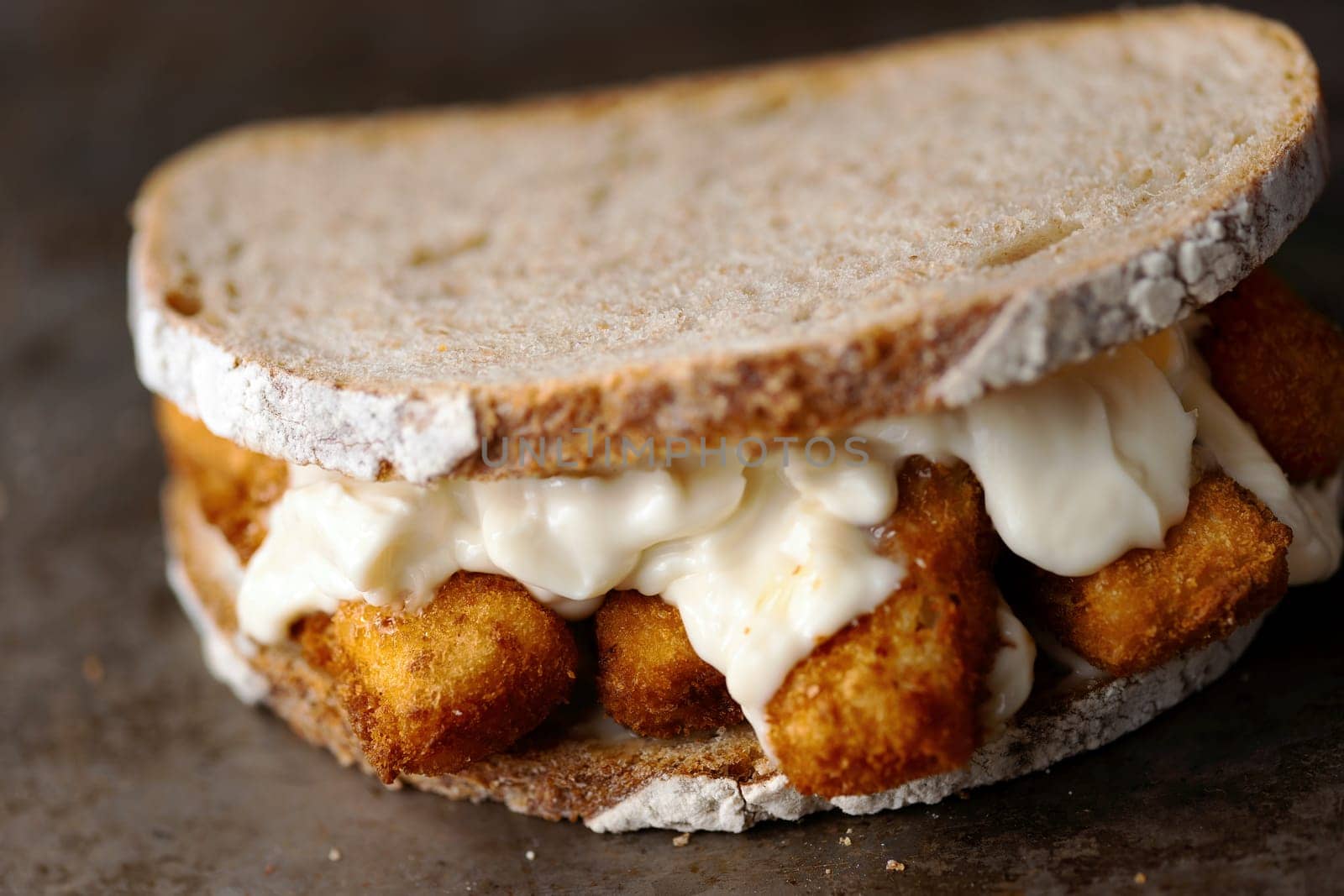 close up of rustic golden english fish fingers sandwich