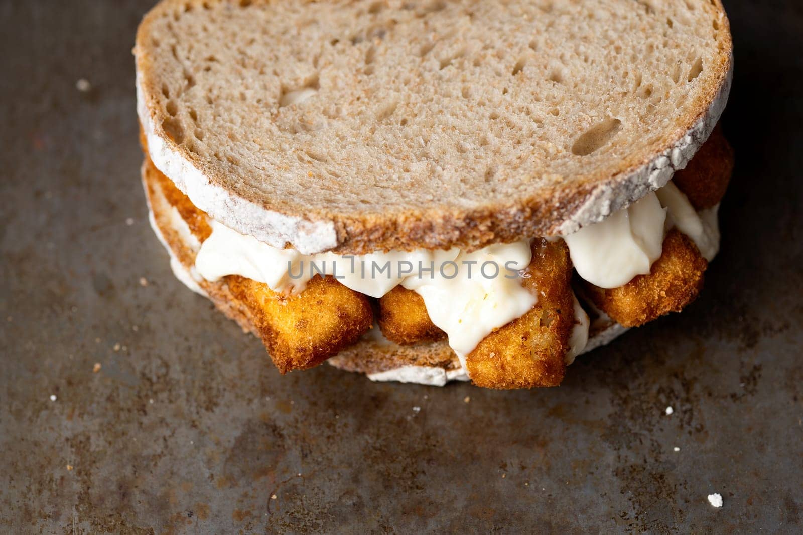 close up of rustic golden english fish fingers sandwich
