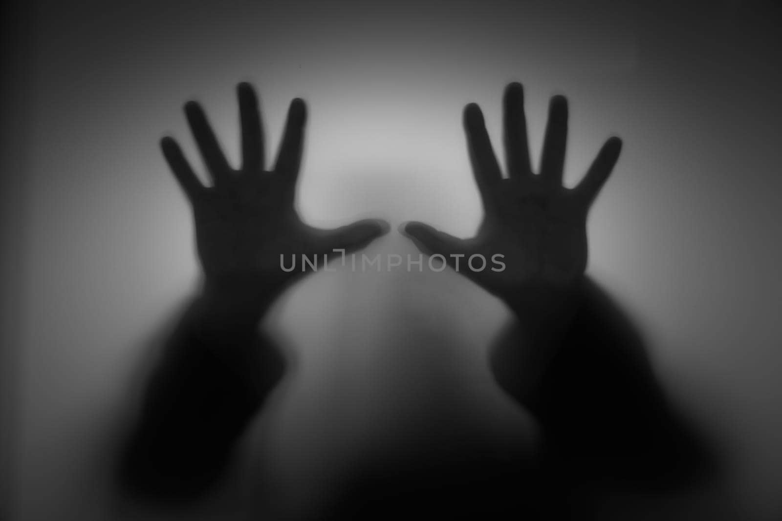 Shadow hands through glass, faceless person, fear