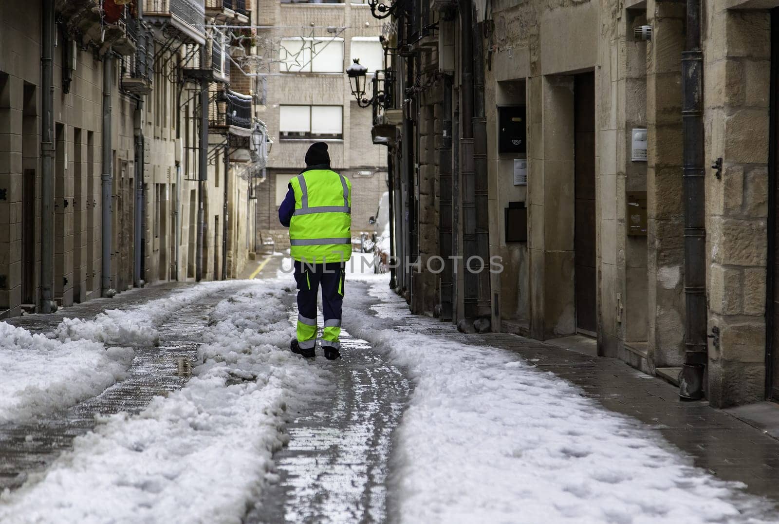 Man cleaning snowy street, winter storm, nature