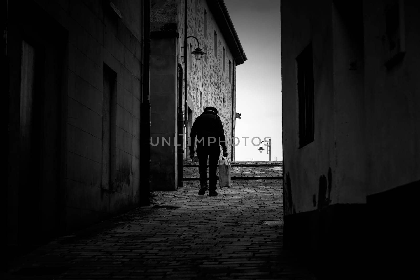 Man walking dark town street, active old age, retirement