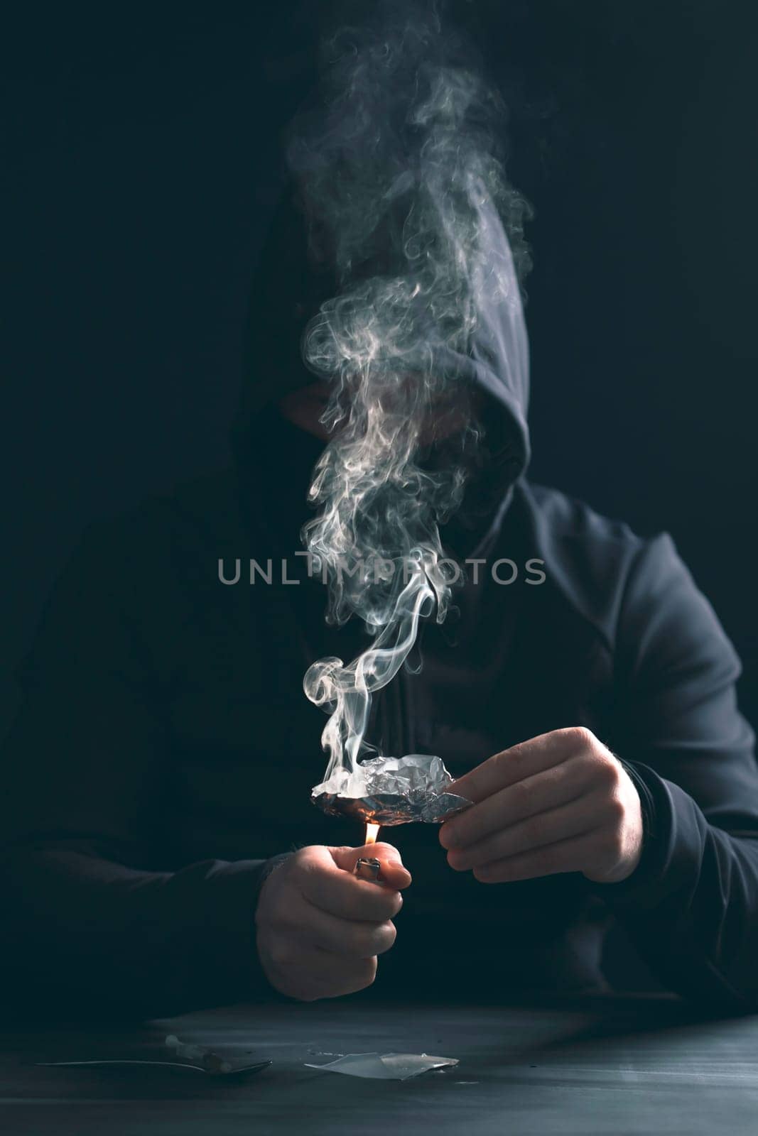 Addict/junkie man preparing drugs. The concept of crime and drug addiction.
