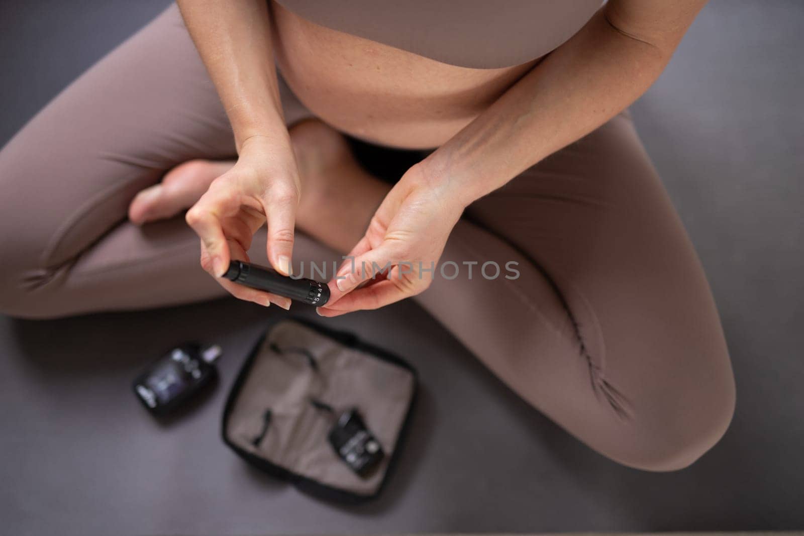 Blood sugar testing at home. Pregnant woman checking blood sugar level by glucometer and test stripe at home. Diabetic checking blood sugar levels