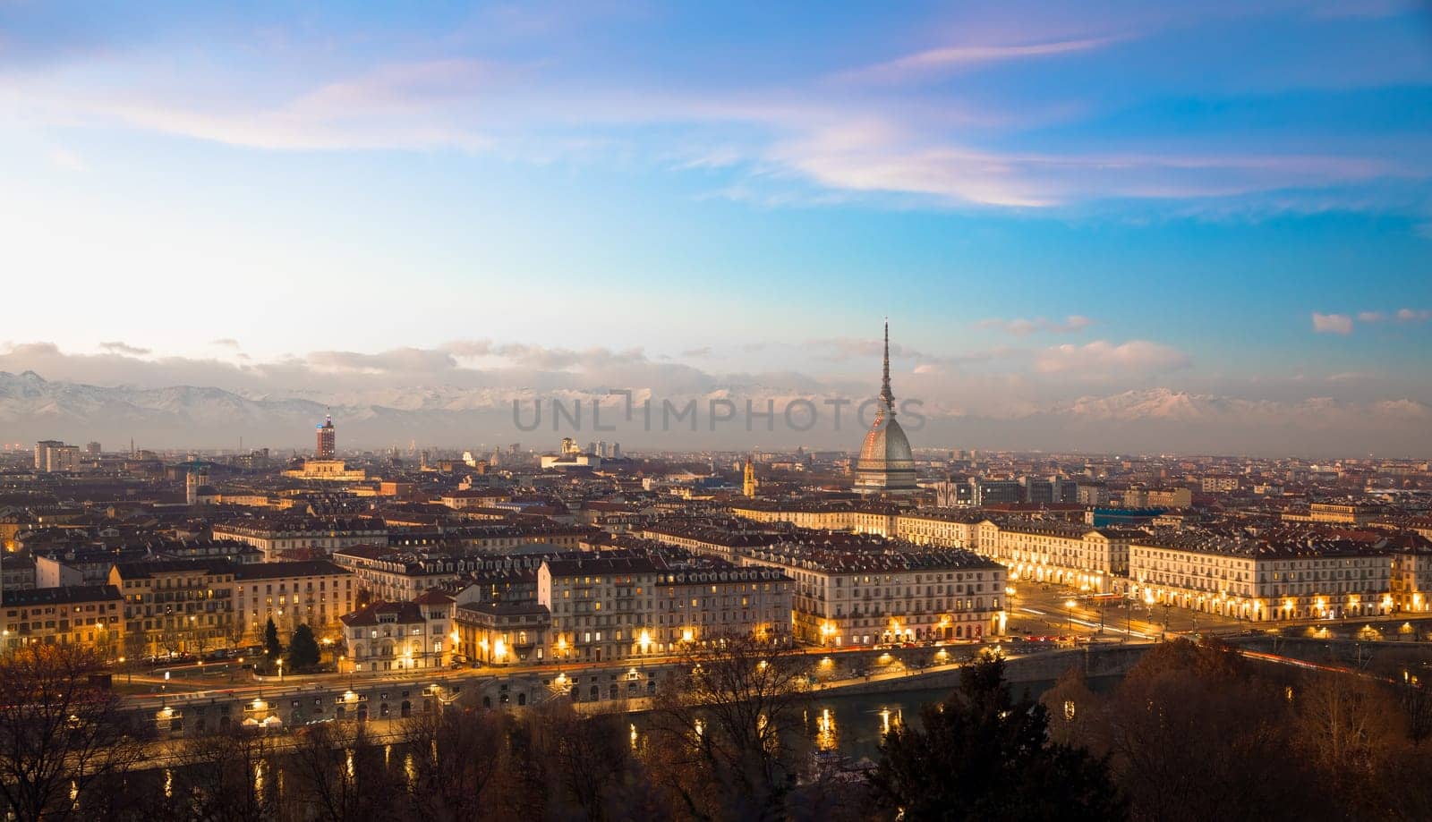 Turin, Piedmont Region, Italy. Panorama from Monte dei Cappuccini (Cappuccini's Hill) at sunset with Alps mountains and Mole Antonelliana monument.