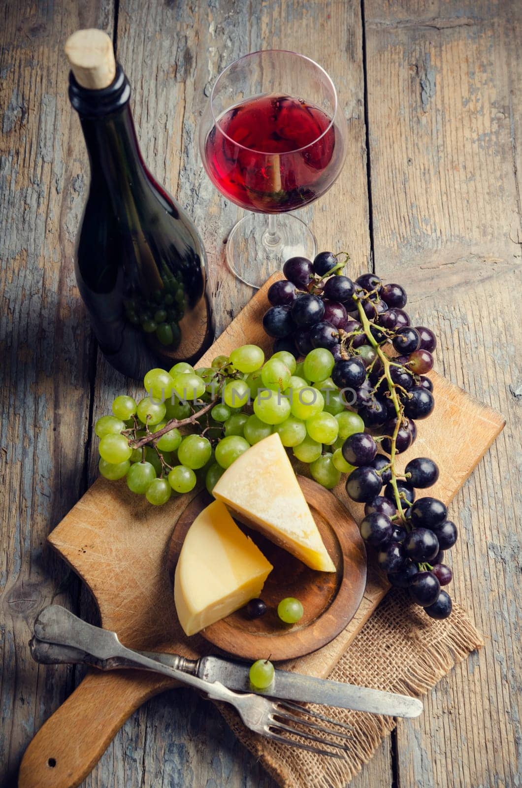 Wine and cheese on rustic wooden table