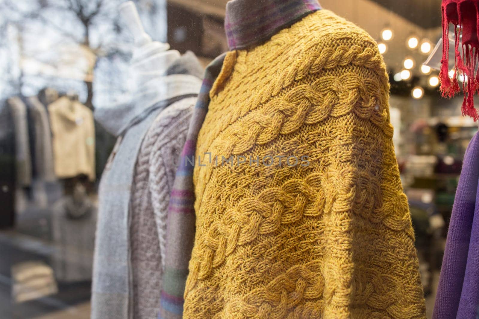 Dublin, Ireland - Feb 9th, 2020: Aran poncho, traditional knitted item with cable patterns. Dublin shop, Ireland