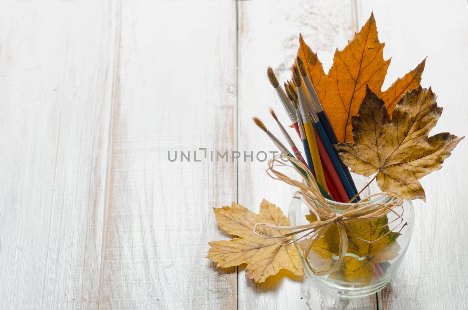 Art brushes and maple leaves. Art concept.