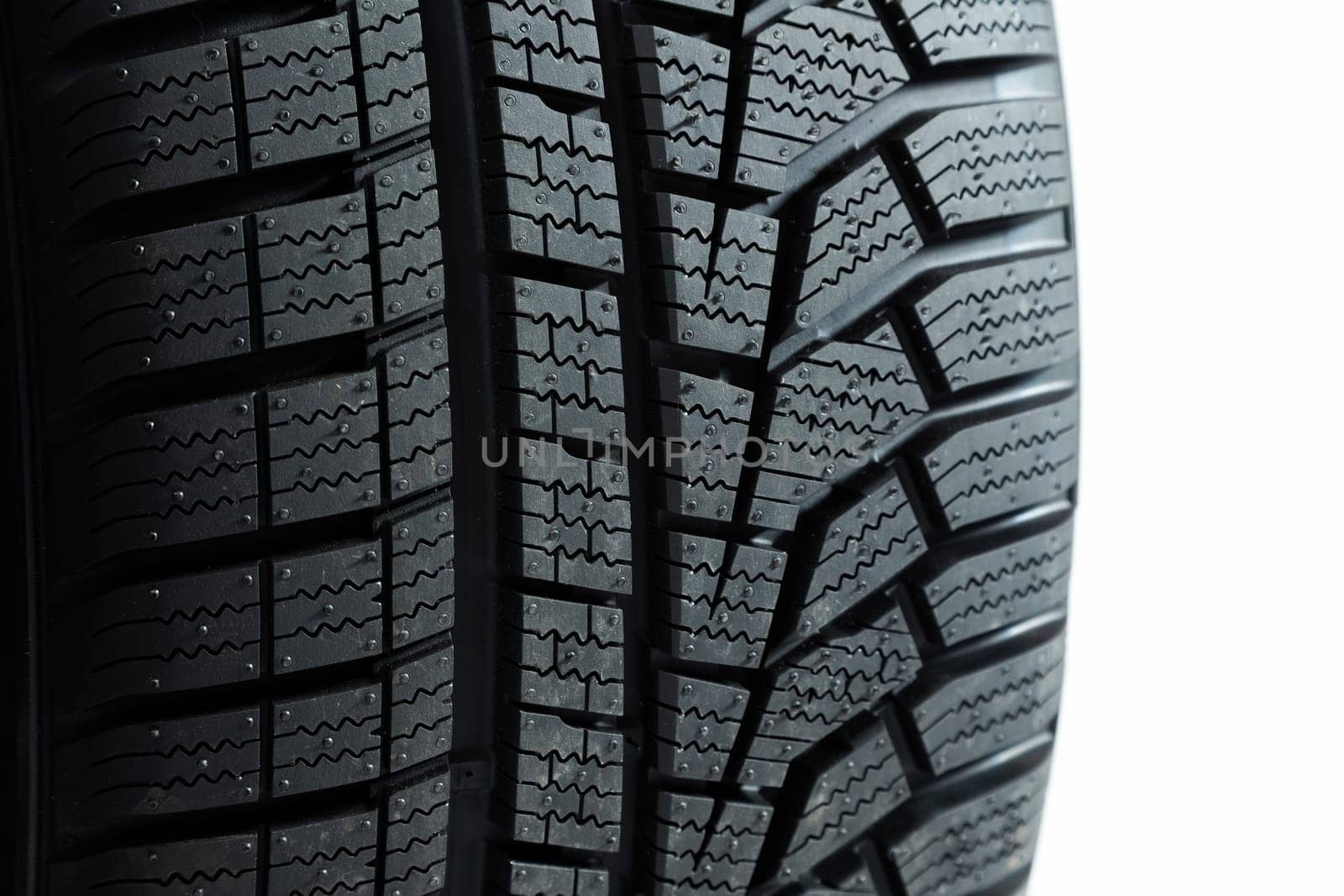 Pattern of tires in close up isolated on white background. wheel cut out. Structured rubber on automobile in detail. Textured wheels shot in studio.