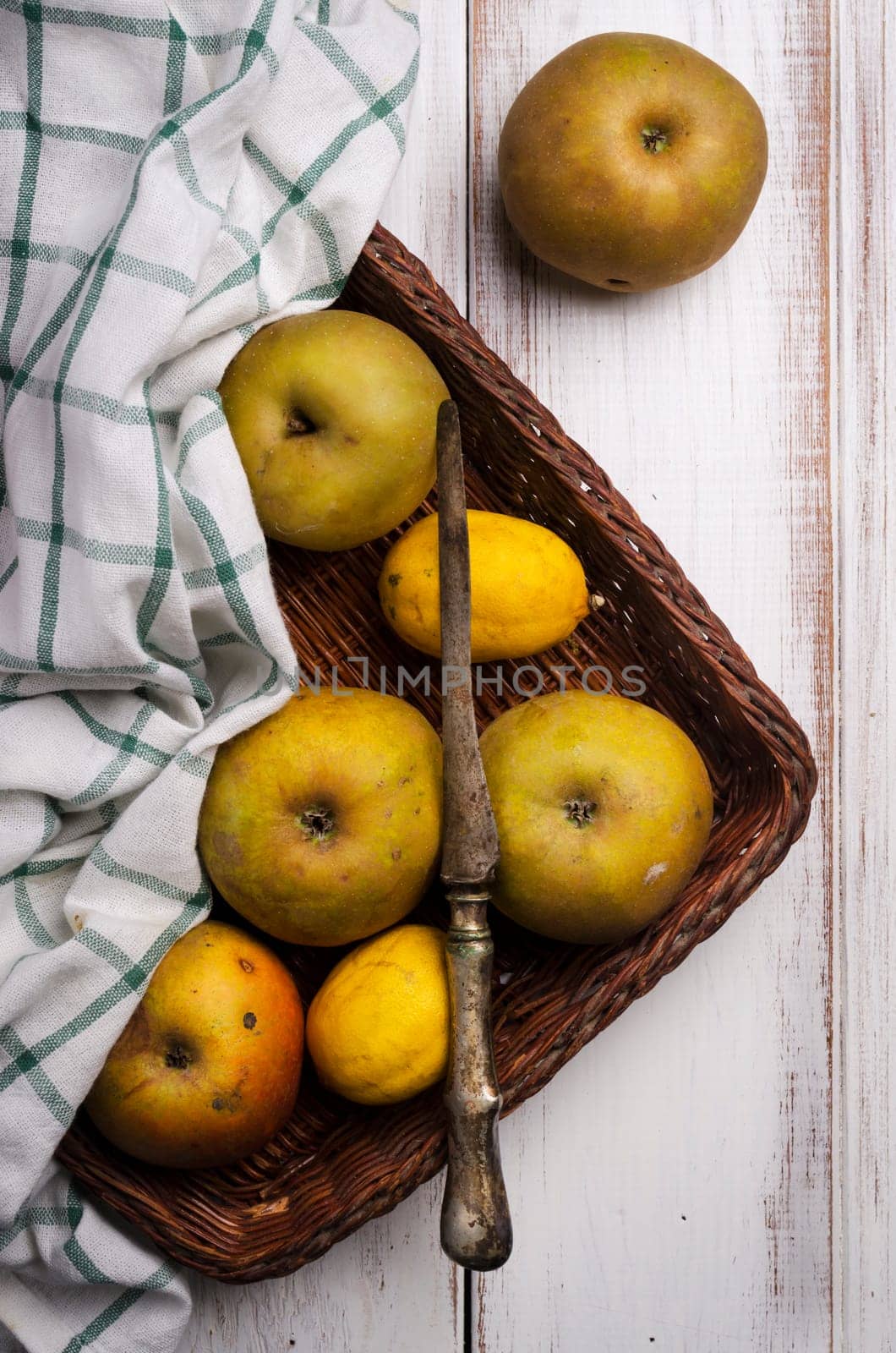 Yellow apples on white rustic table