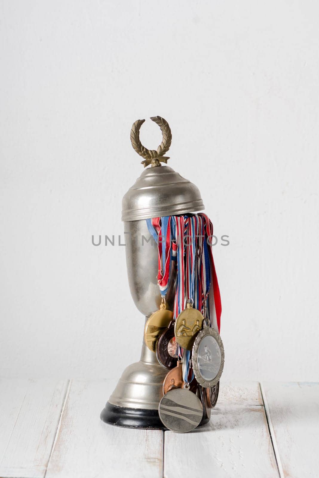 Trophy full of medals over white wall