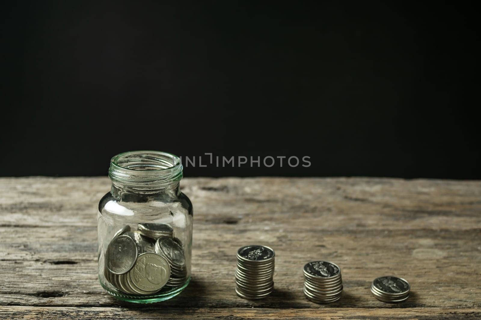 Save money and account banking for finance concept, Hand with coin on piggy bank blurred background