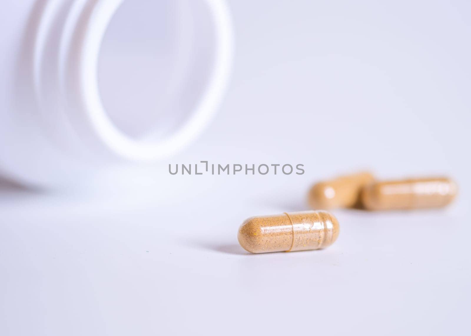 Pill spilling out of a bottle blurred background, Medicine capsule for health, Vitamin spilling out from bottle, Macro