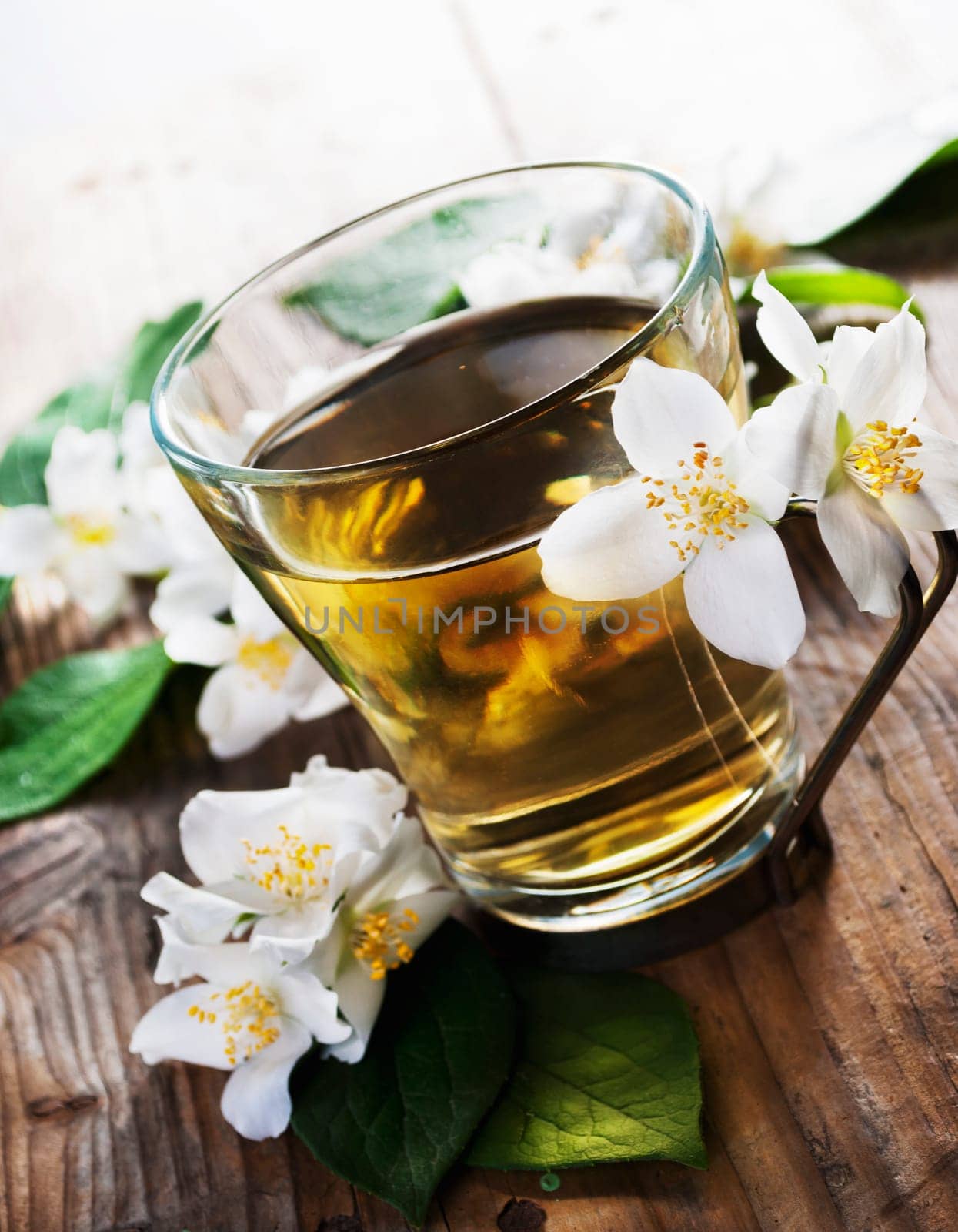 Cup of jasmine tea on wooden table