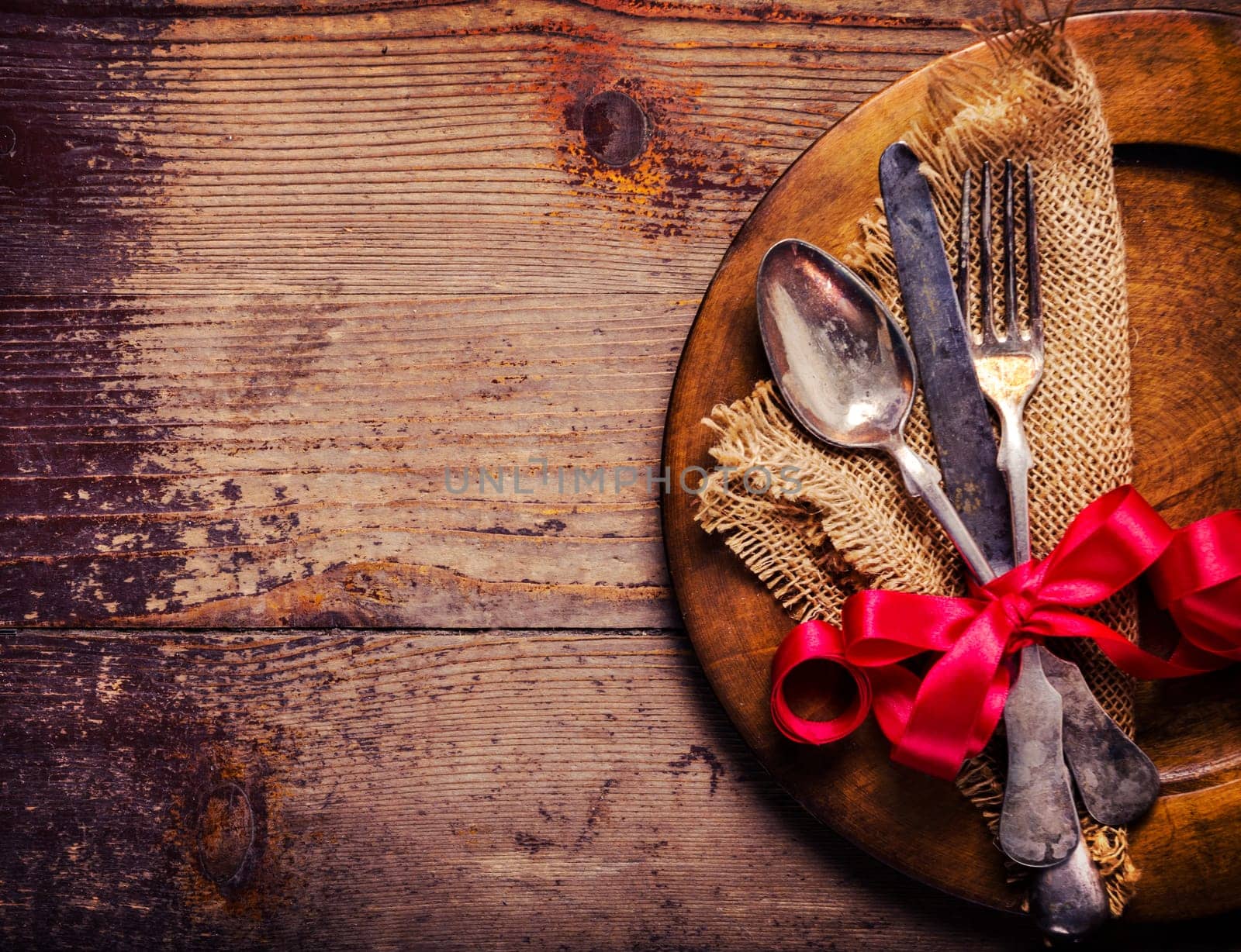 Vintage silverware decorated with red ribbon
