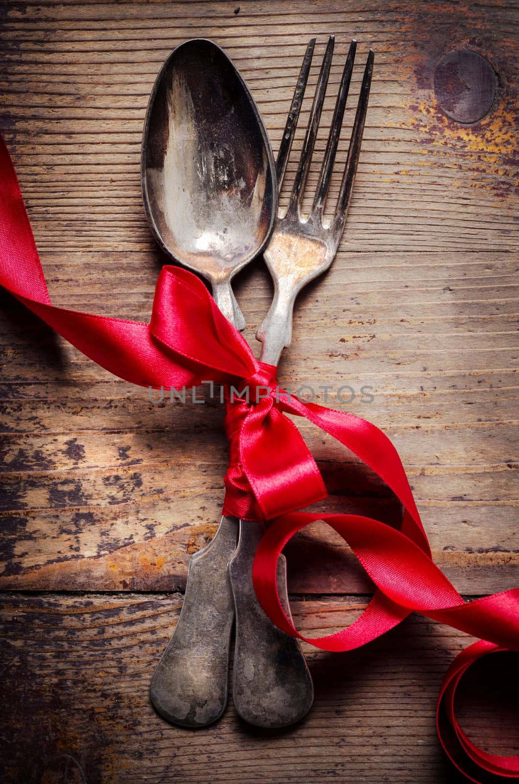 Vintage silverware decorated with red ribbon