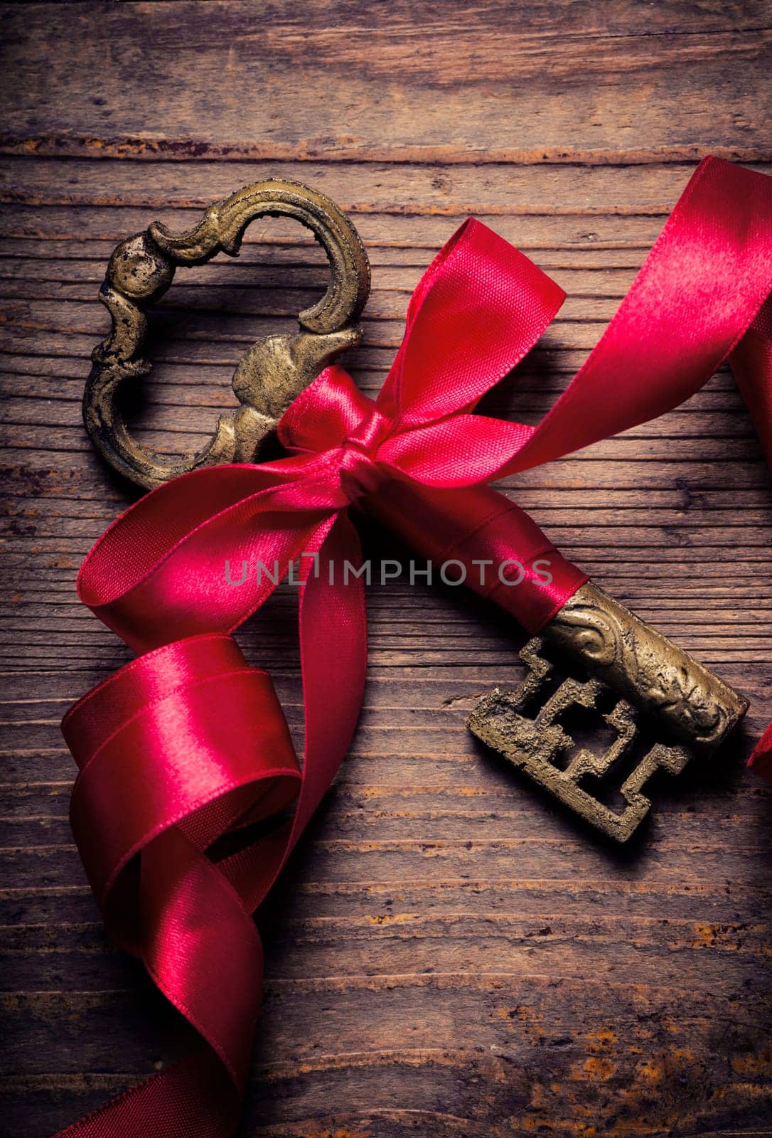Old key decorated with red ribbon