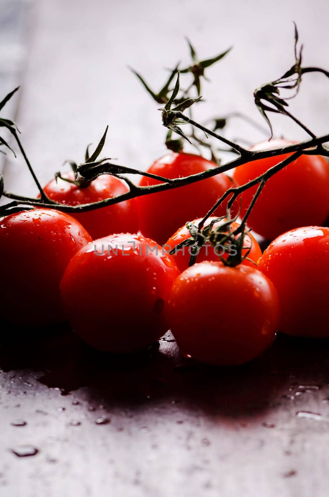 Close up of cherry tomatoes with water drops.