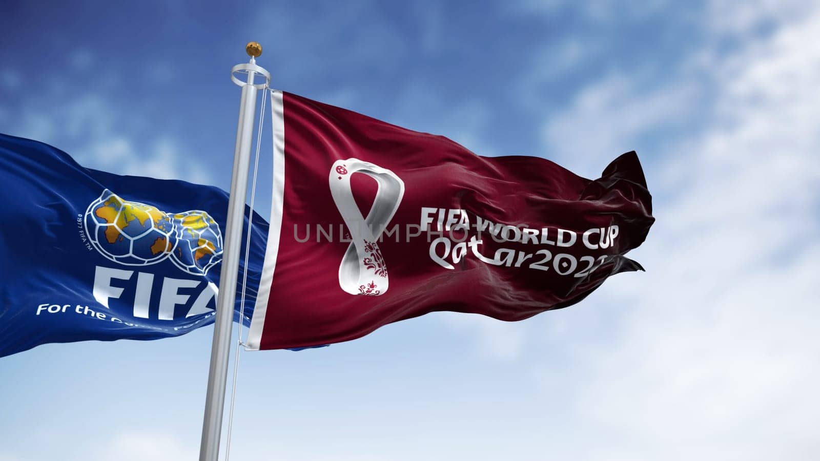 Doha, Qatar, January 2022: Flags with FIFA and Qatar 2022 World Cup logo waving in the wind. The event is scheduled in Qatar from 21 November to 18 December 2022