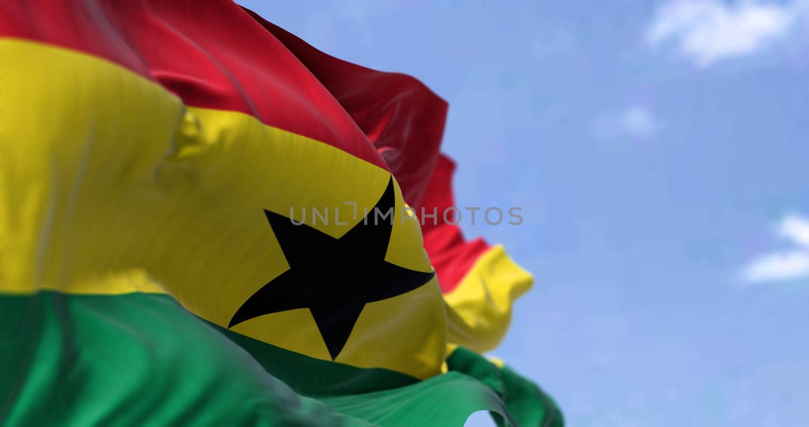 Detail of the national flag of Ghana waving in the wind on a clear day. Ghana is a country in West Africa. Selective focus.