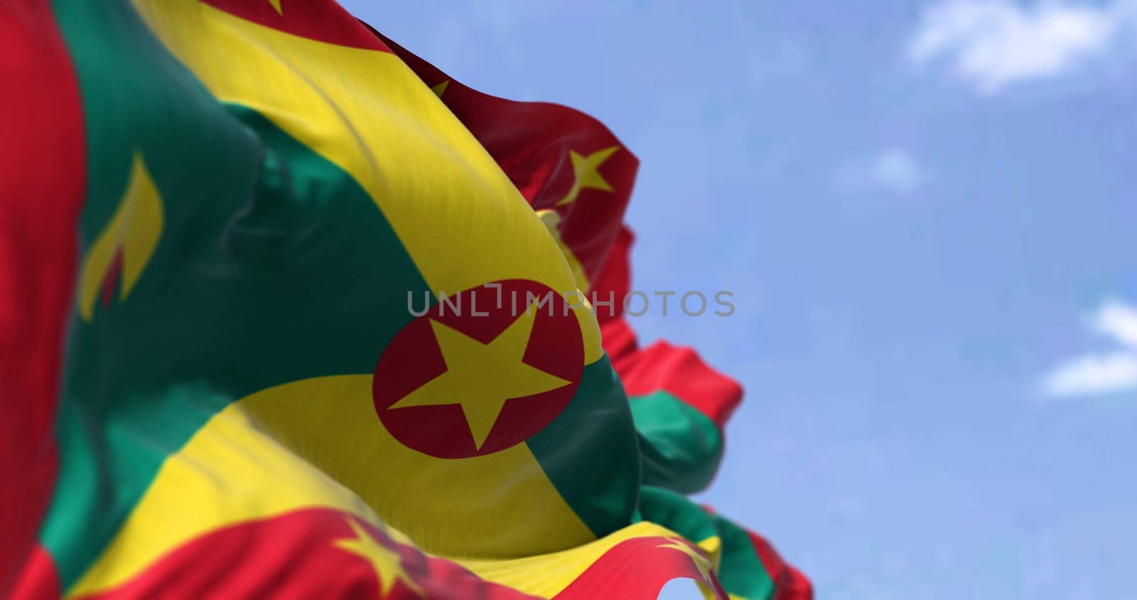 Detail of the national flag of Grenada waving in the wind on a clear day. Grenada is an island country in the West Indies in the Caribbean Sea. Selective focus.