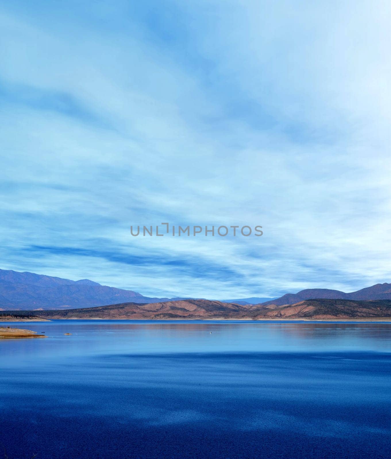Mountain and reflections of Mountain in Roosevelt lake Central Arizona