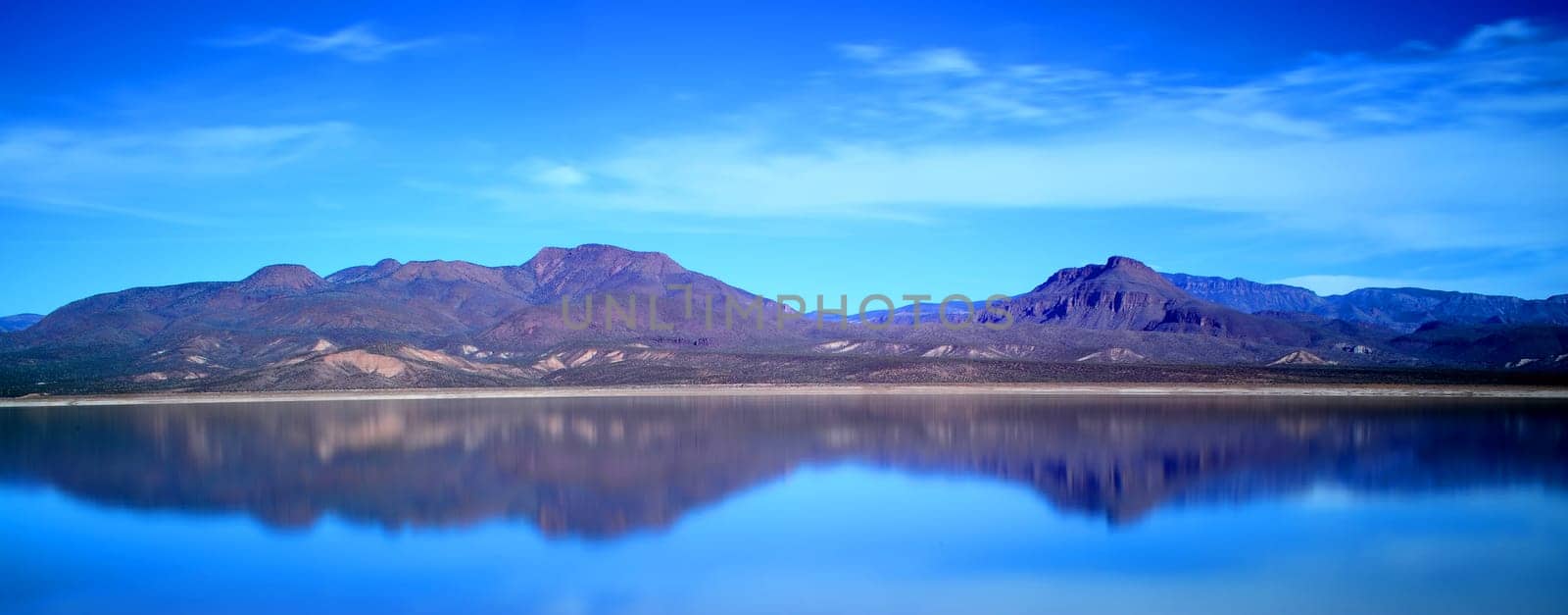 Mountain and reflections of Mountain in Roosevelt lake Central Arizona