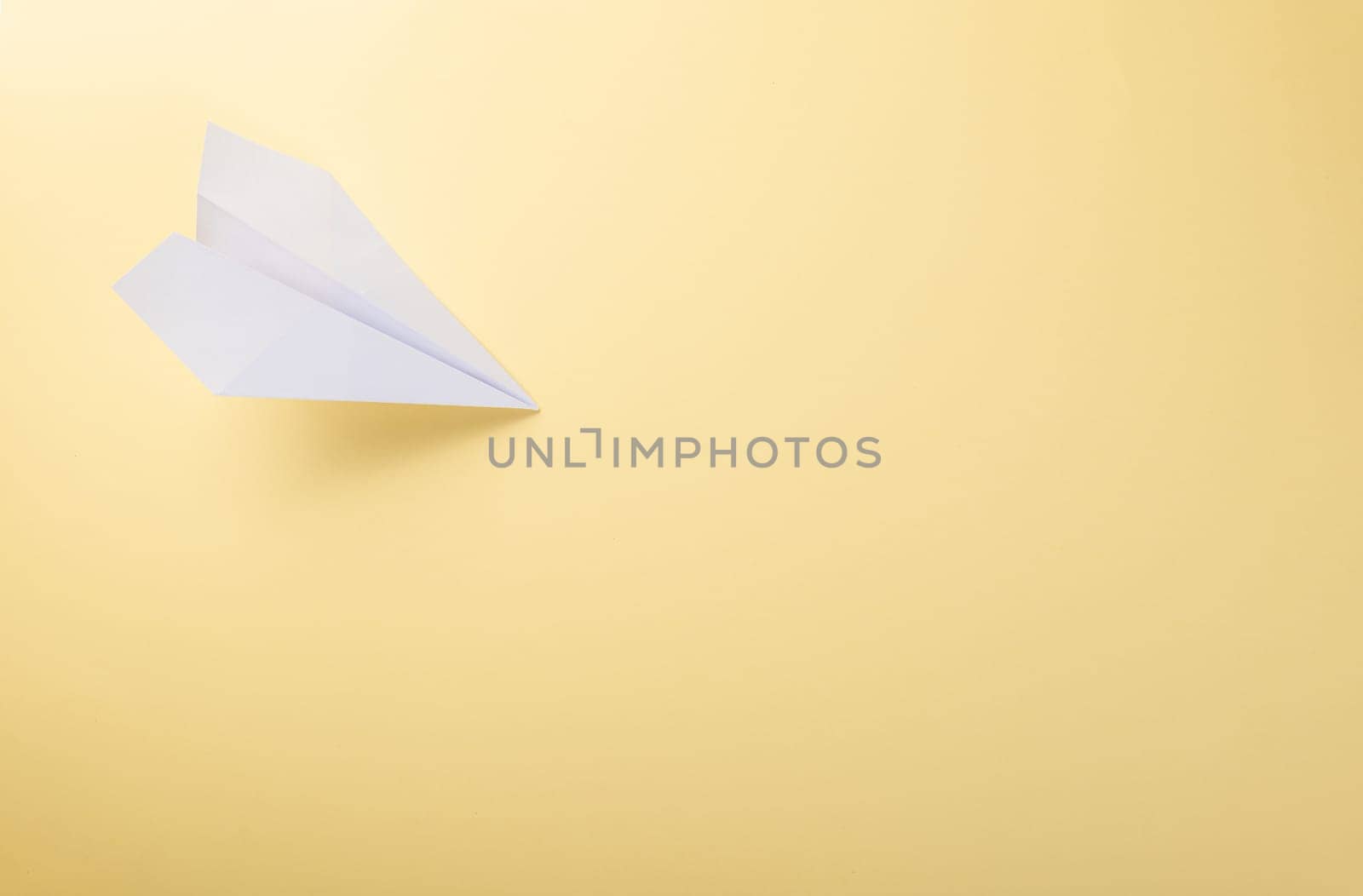 Paper plane letter document message. Top view mock up design of airplane travel tourism, isolated on yellow background with blank empty space for copy space