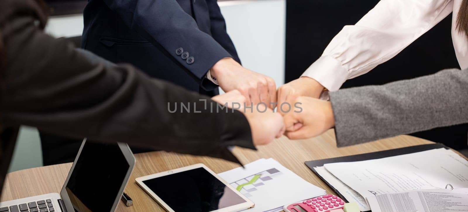 Business people join punching fists bump hands as team their meeting, Giving touch punch together of power teamwork, Business group winning successful company achieving goals with determined staff