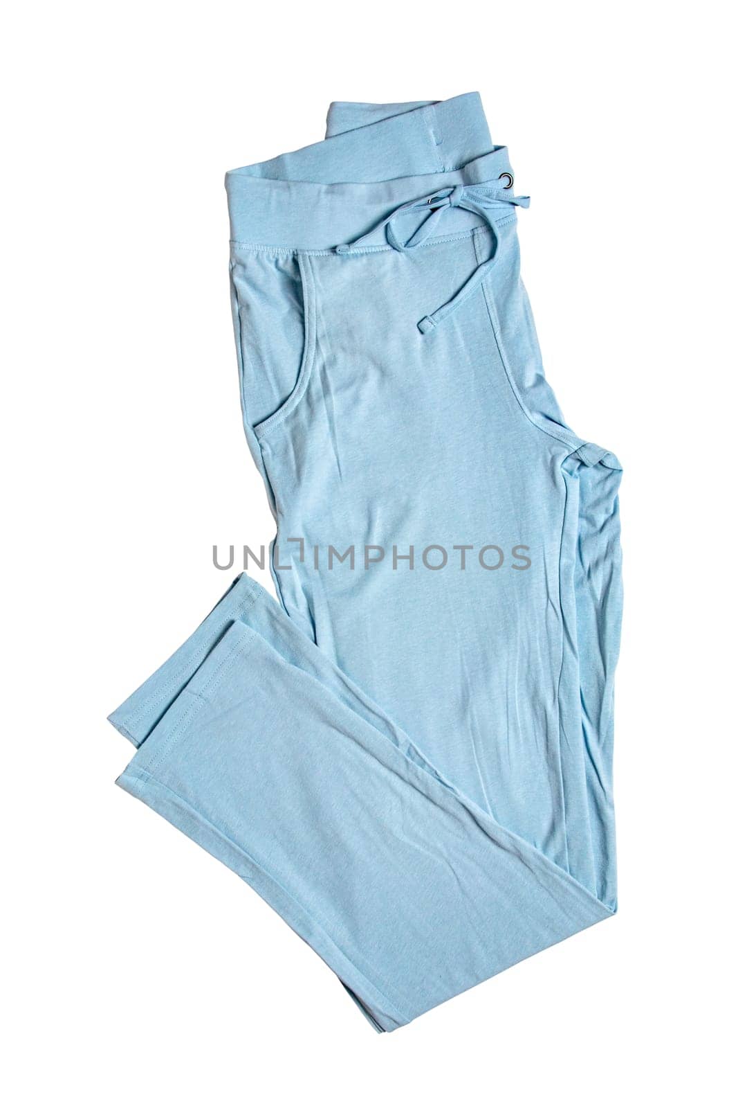 Sweat pants isolated. Close-up of womans fashionable blue casual trousers or jersey trousers isolated on a white background. Jogging outfit for workout. Clipping path.
