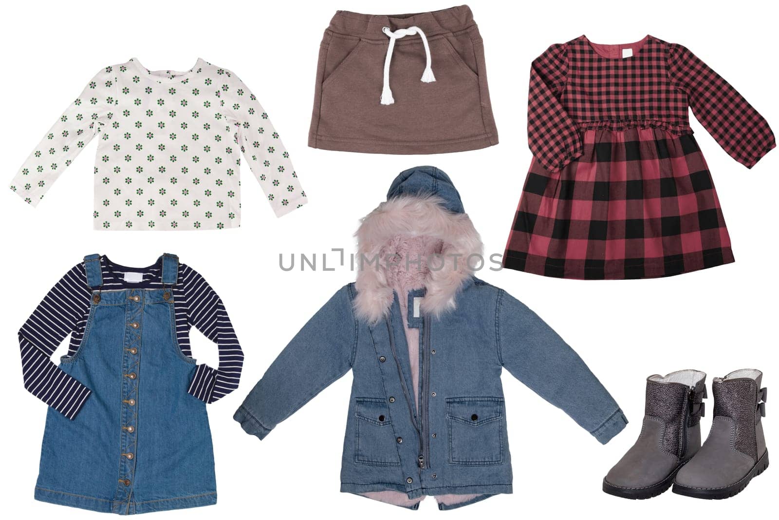 Collage set of little girl spring clothes isolated on a white background. The collection of a jeans jacket, shoes or boots, a jeans dress, a vest, a shirt and a skirt. Kids winter and autumn fashion.