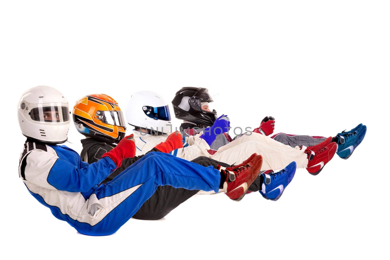 Racing driver in racing position with complete gear isolated in white