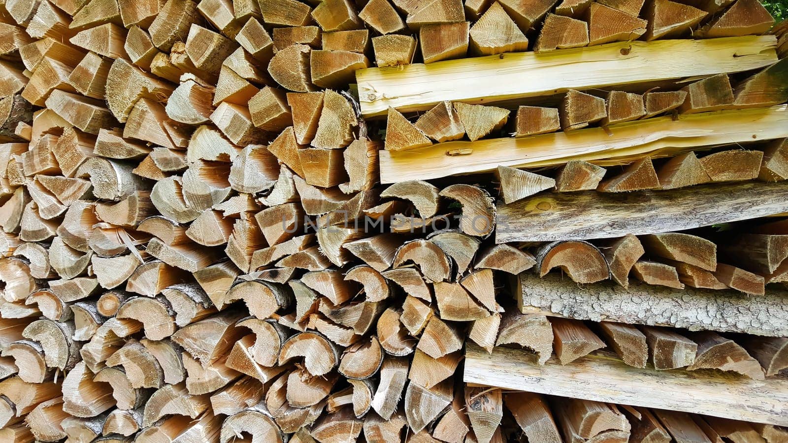 Firewood in the meter on the pile of wood