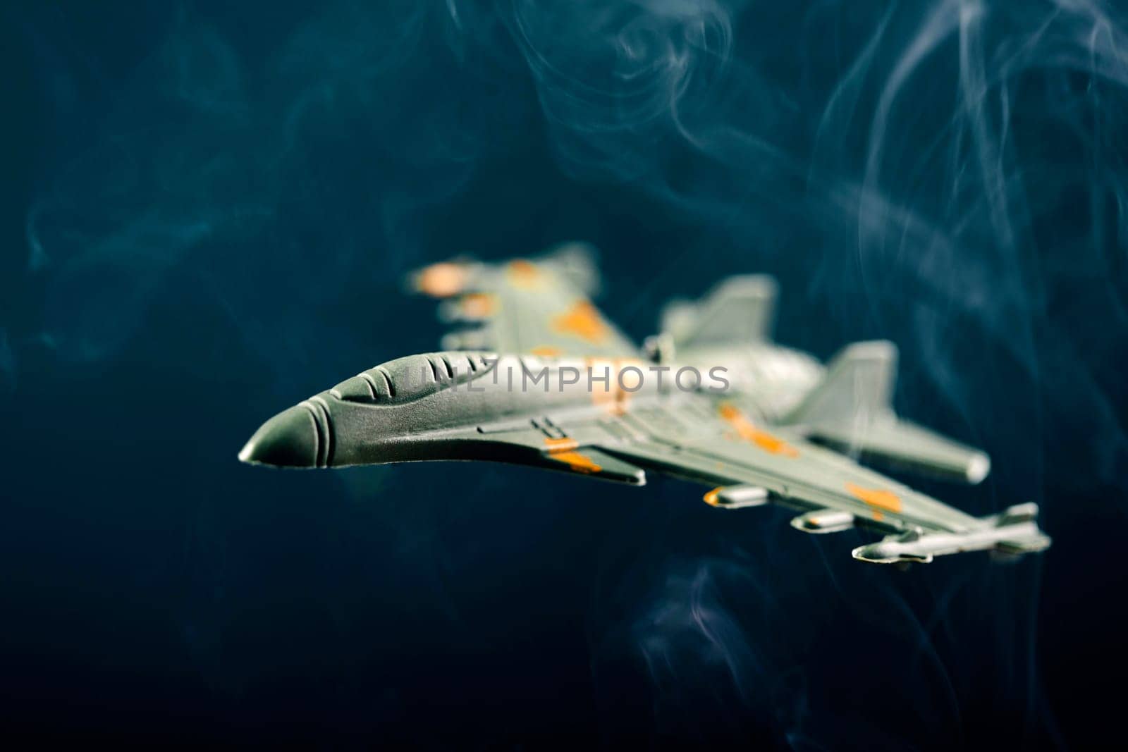 Jet fighter airplane silhouette on blue background with smoke