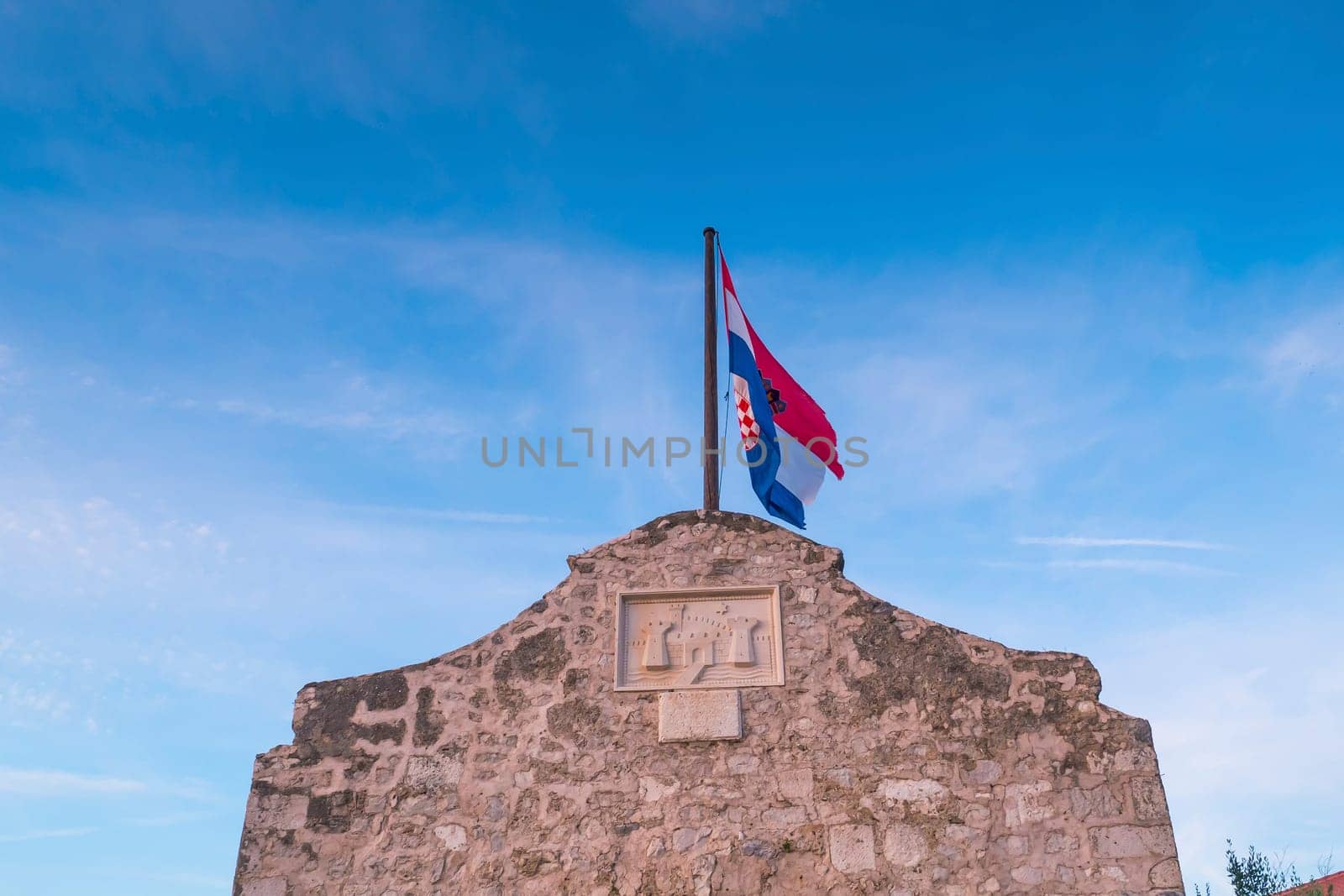 Croatian flag and gate tower to historic town Nin, Dalmatia, Croatia