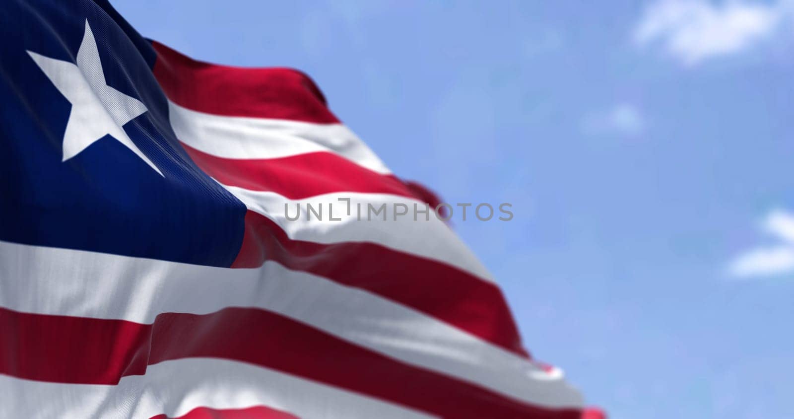 Detail of the national flag of Liberia waving in the wind on a clear day. Liberia is a country on the West African coast. Selective focus.