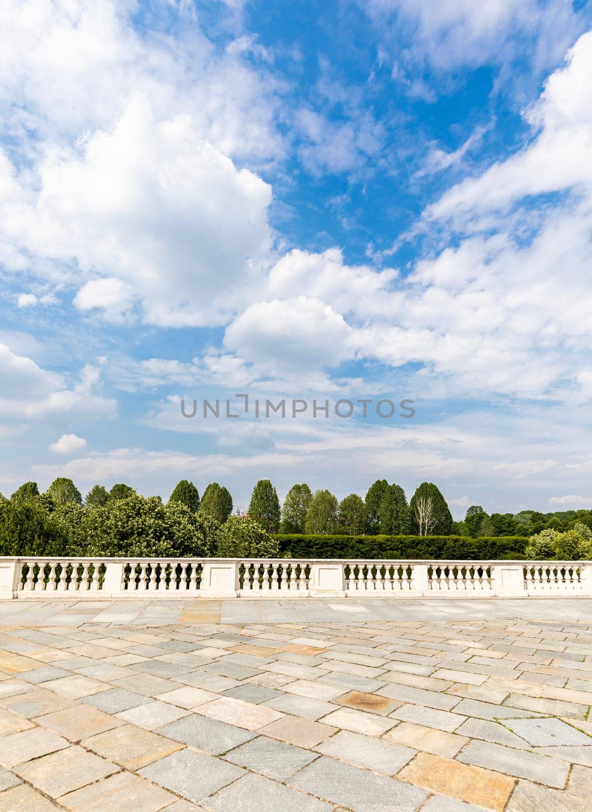 Exterior with old grey floor made of stone. Vintage textured pavement and blue sky in the background.