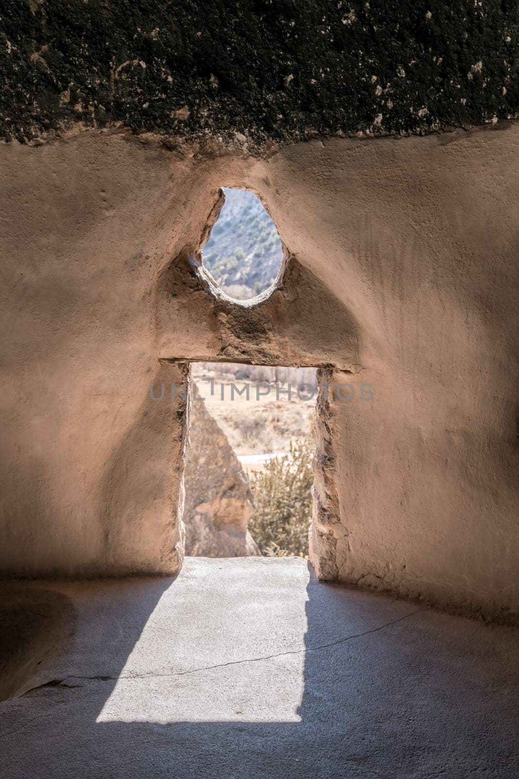 A view from inside of cavate - a natural cavity in the cliff expanded by the dwellers. Bandelier National Monument, New Mexico