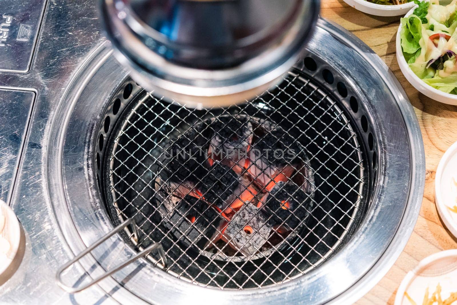 Korean BBQ stove and smoke hood. grill to place the meat to grill and below lit with charcoal at restaurant