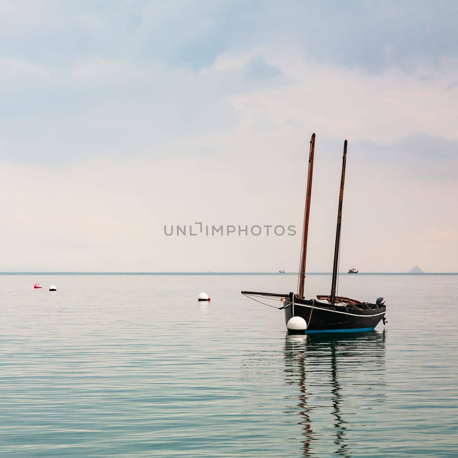 Boat reflecting over calm sea in Cancale, Brittany, France