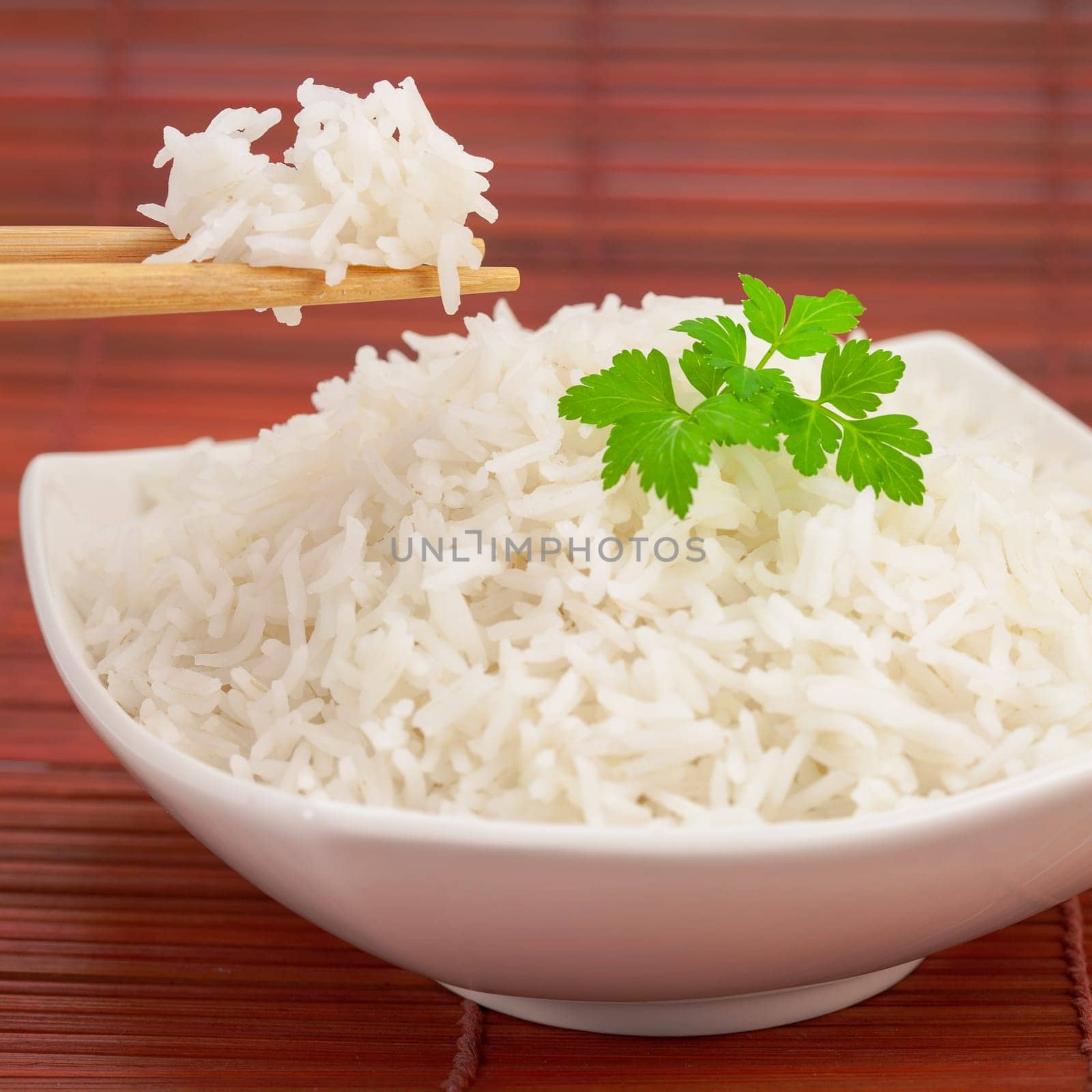 Japan rice with chopsticks on a bamboo mat