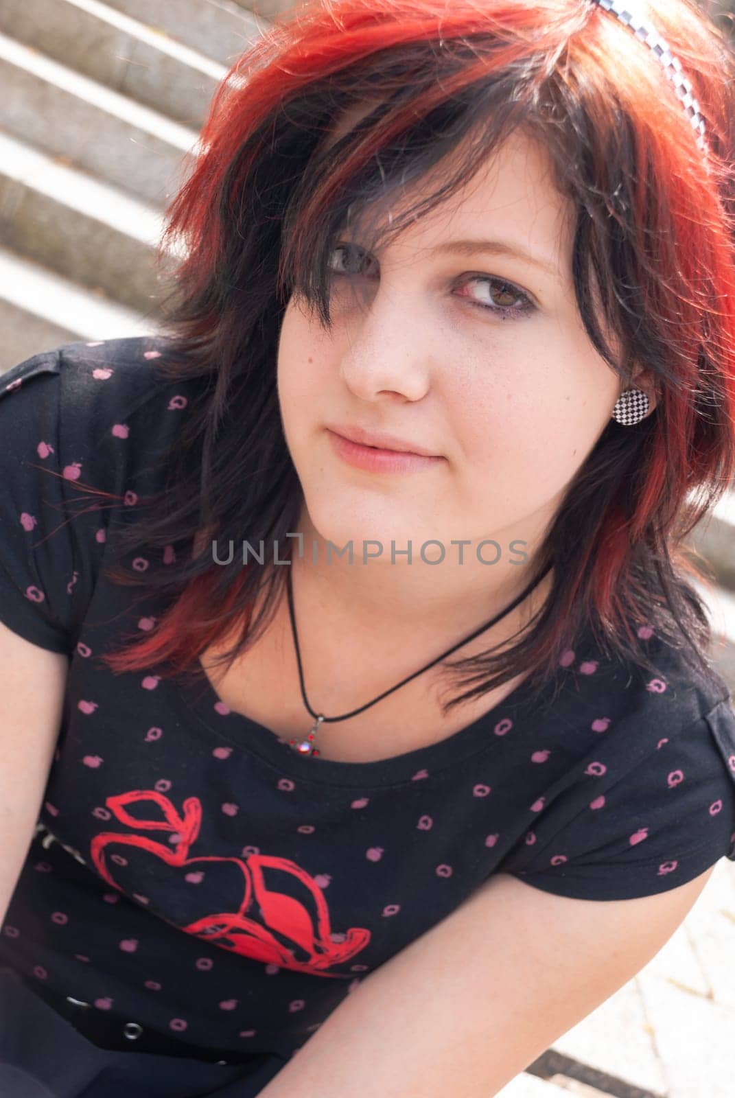 Punk emo girl, young adult with black red hair, looking at camera, close-up, horizontal