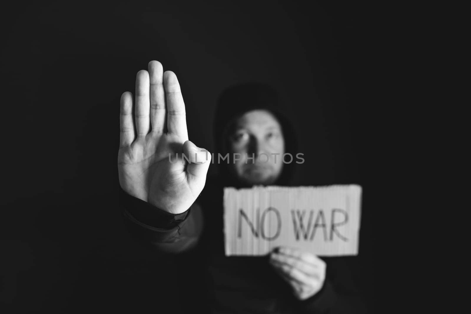 Man holding placard No war text. Freedom to Ukraine concept.