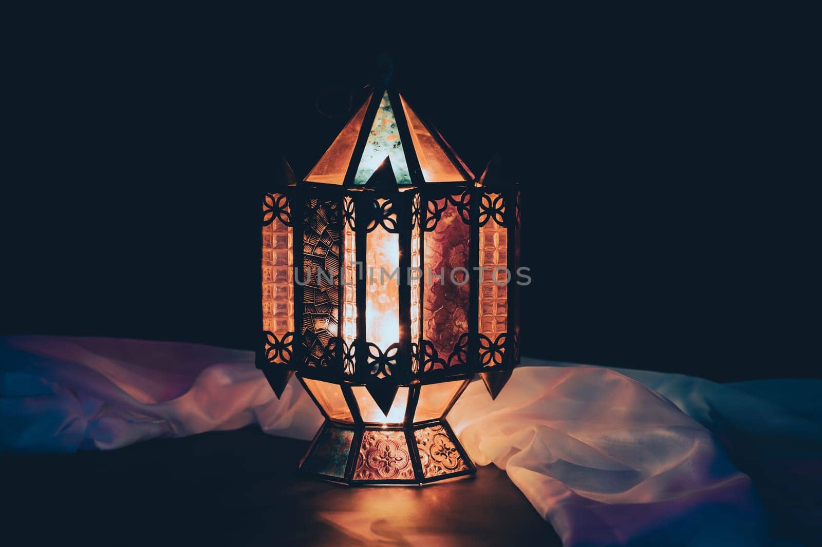 Ramadan Kareem background. Ornamental Arabic lantern glowing at night