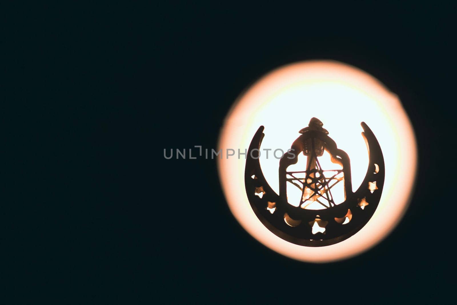 Ramadan Kareem background. Ornamental Arabic lantern glowing at night