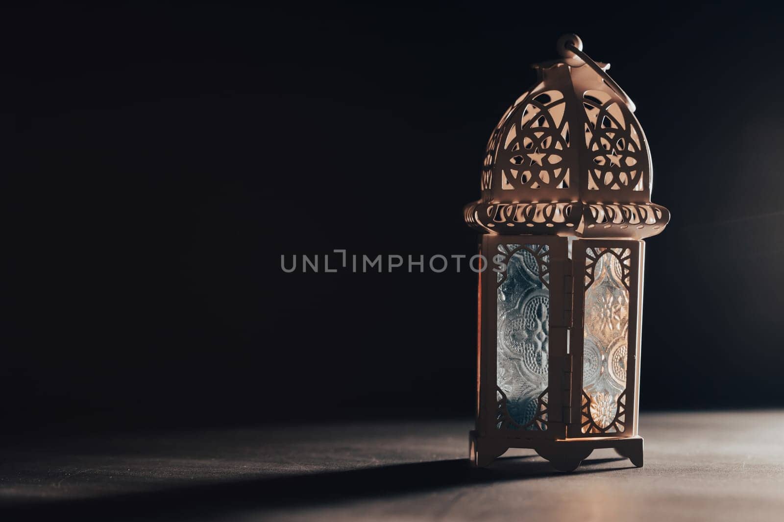 Ramadan Kareem background. Ornamental Arabic lantern glowing at night