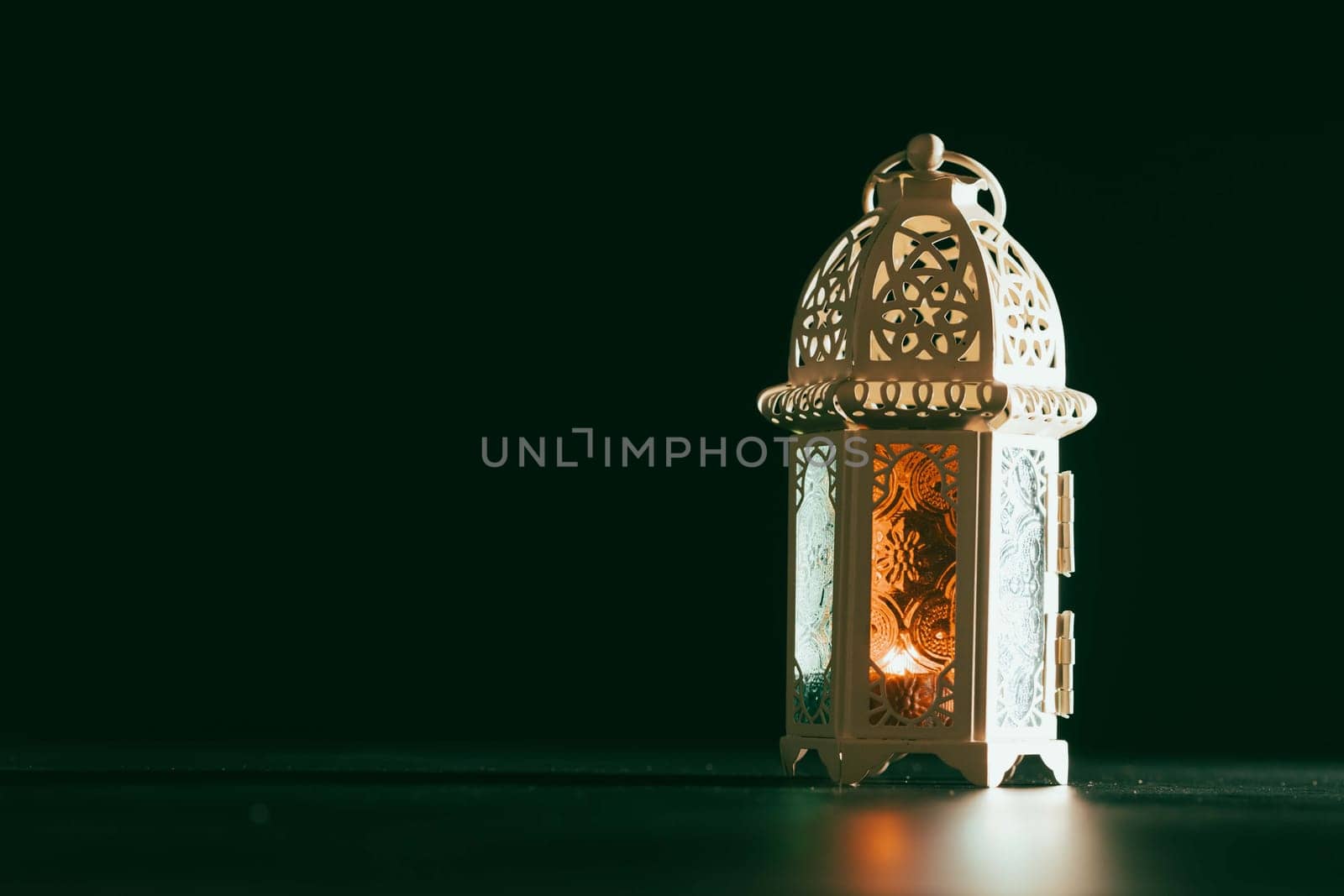 Ramadan Kareem background. Ornamental Arabic lantern glowing at night