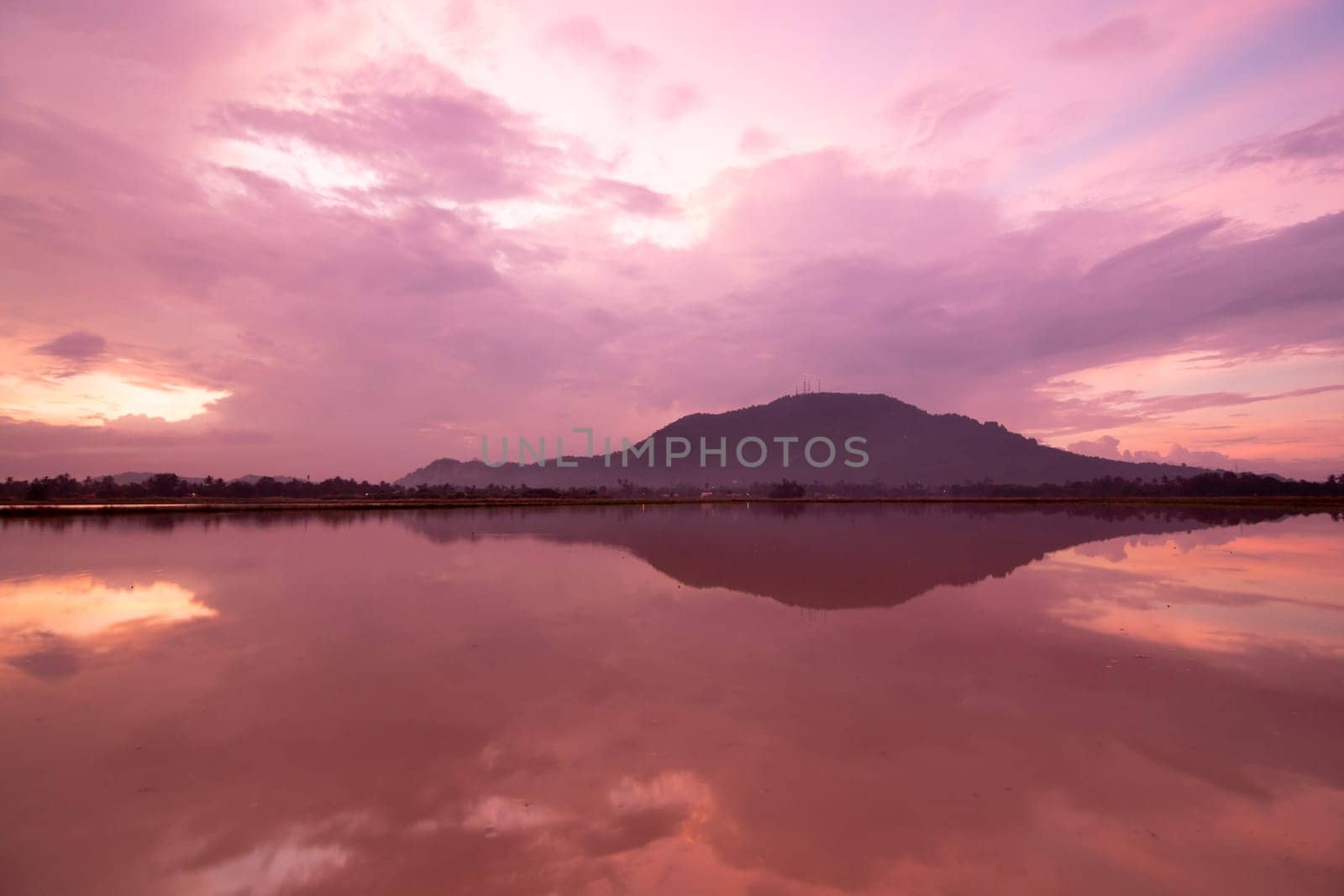 Beautiful morning red sky reflection of the hill in water