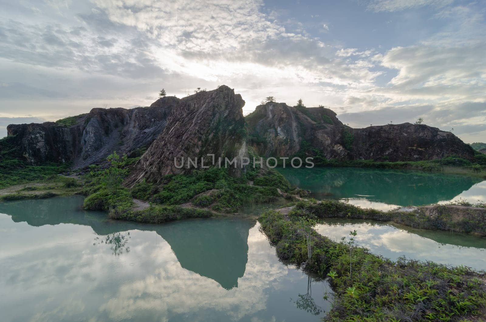 Beautiful scenery reflection of abandoned quarry hill in day