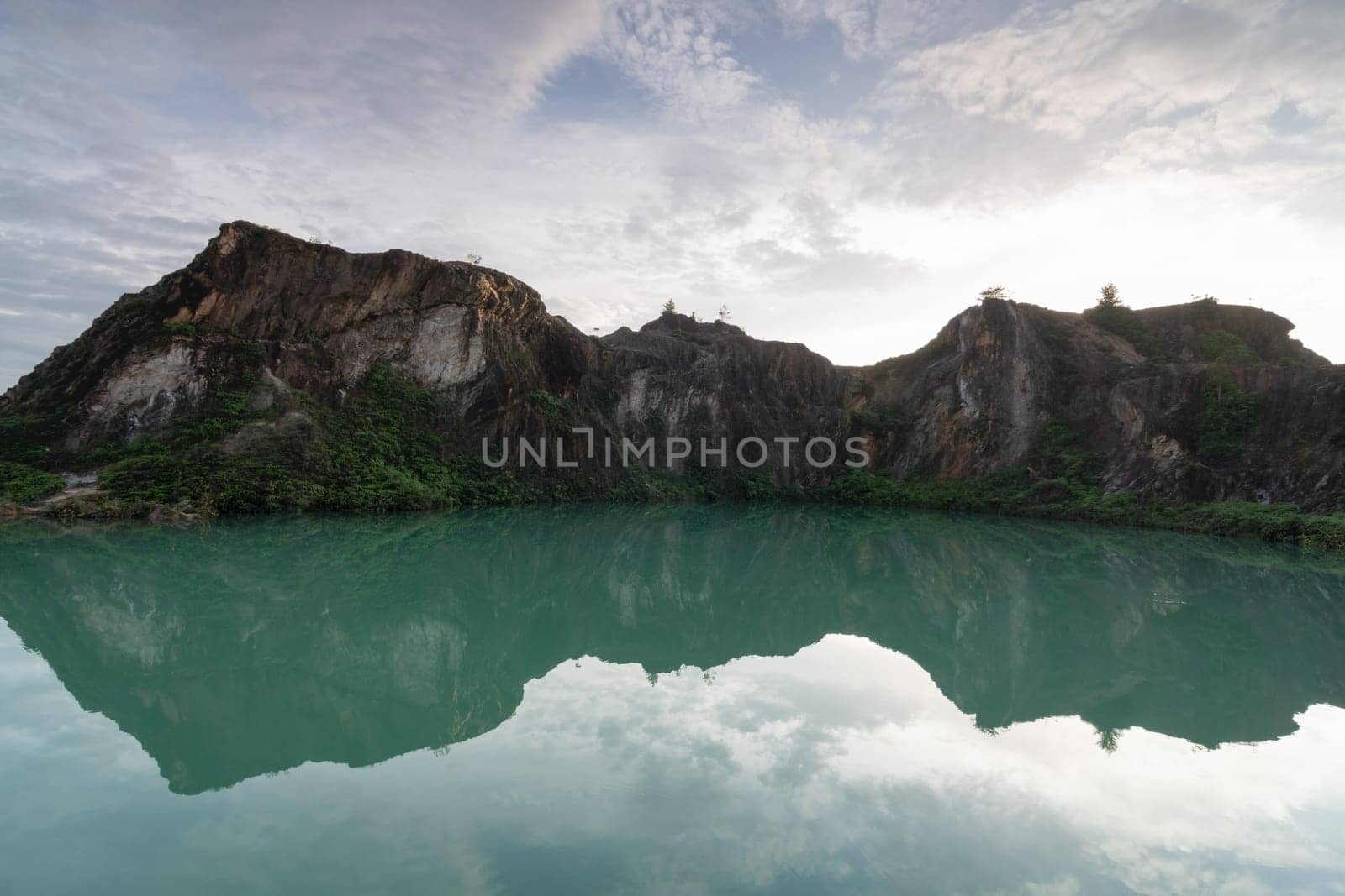 Reflection of mirror beauty abandoned quarry in cloudy day