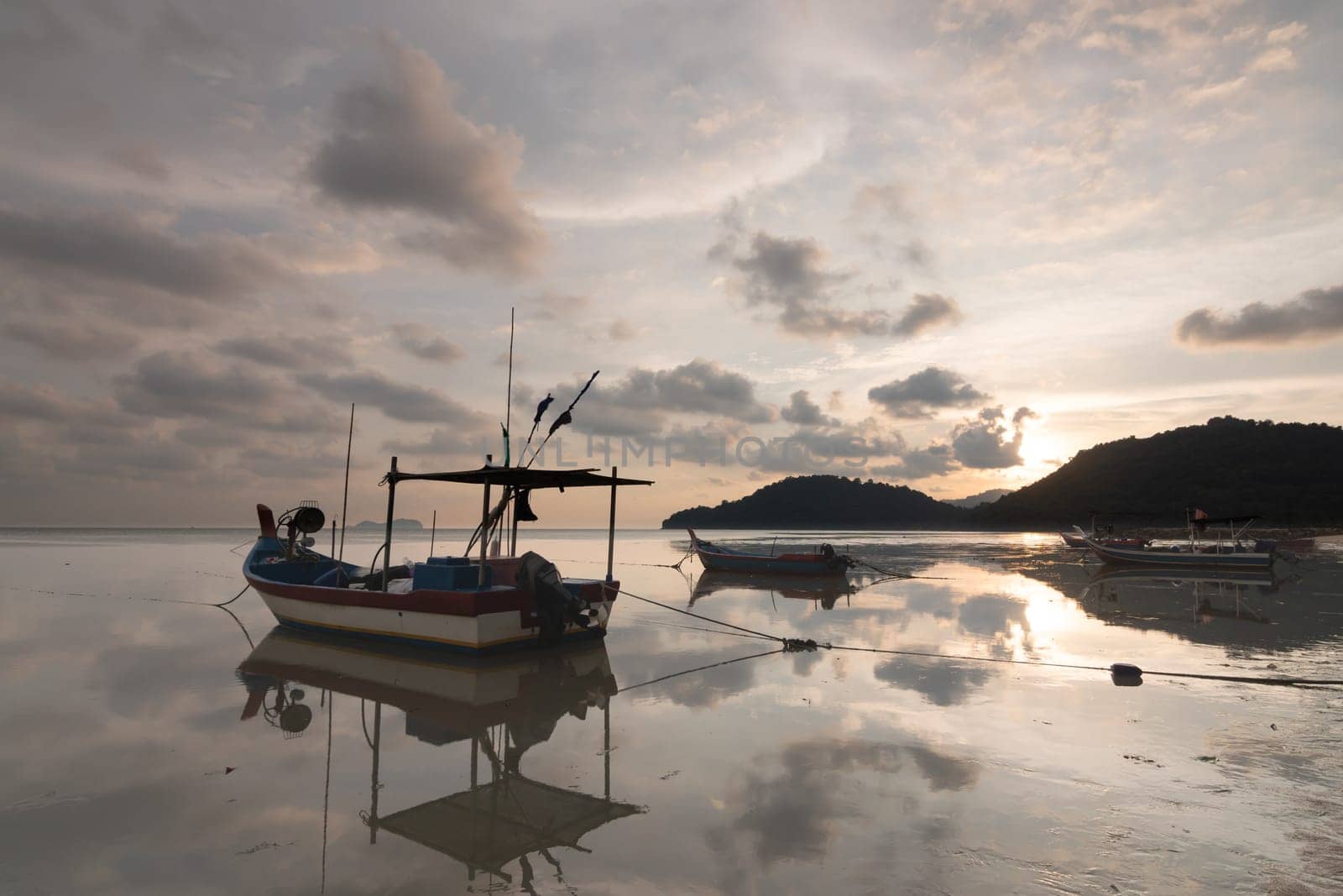 Reflection of boats at sea coastal in sunset evening